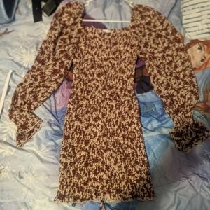 A cream dress with burgendy flowers puffy sleeves , fitted